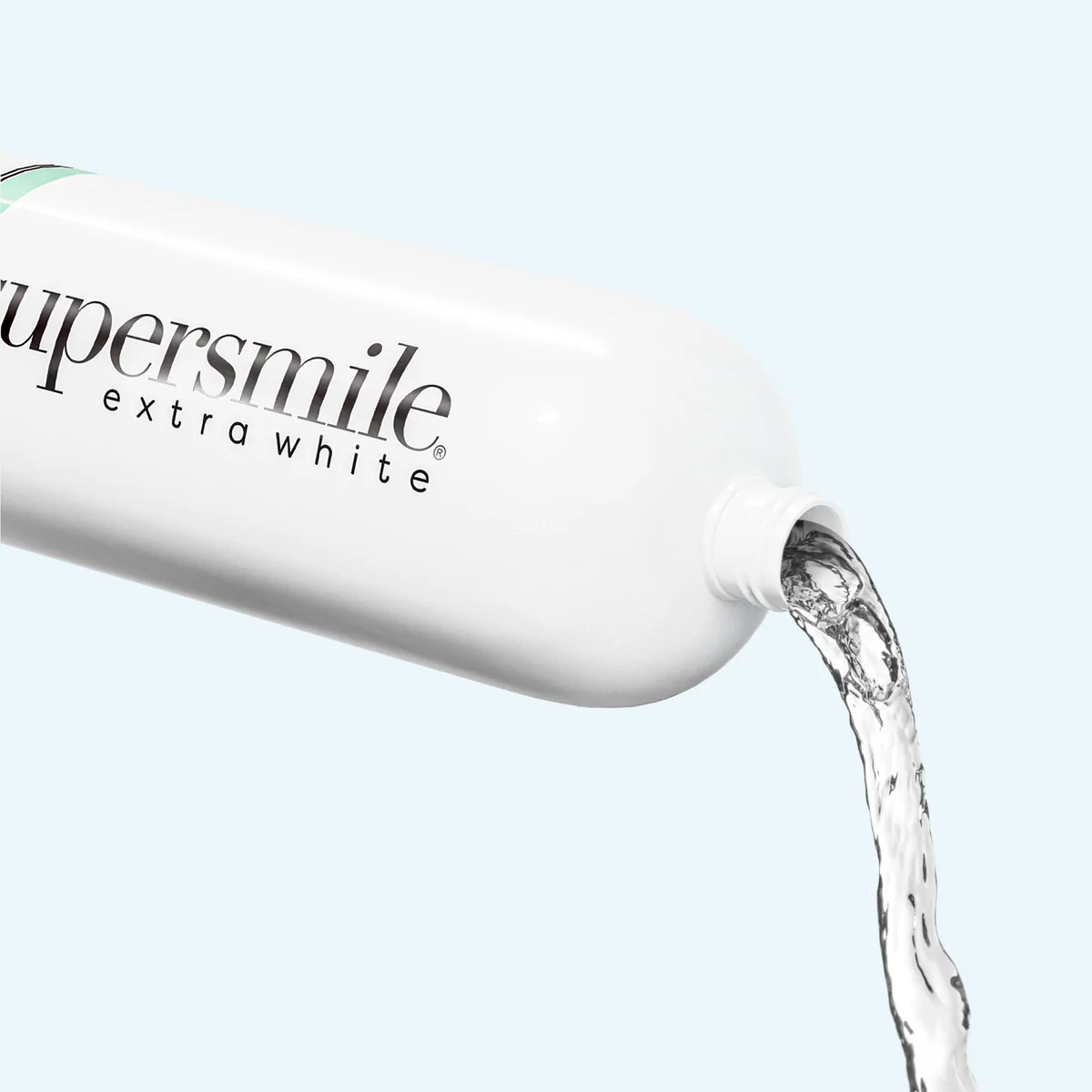 Supersmile Extra White product with liquid being poured out on a light background