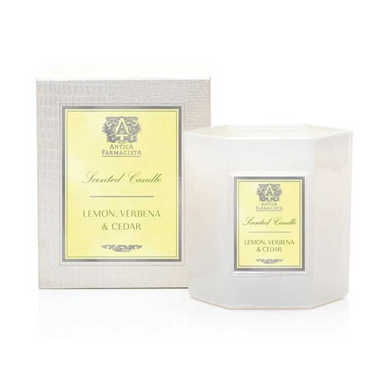 Lemon, Verbena & Cedar Candle next to its box.