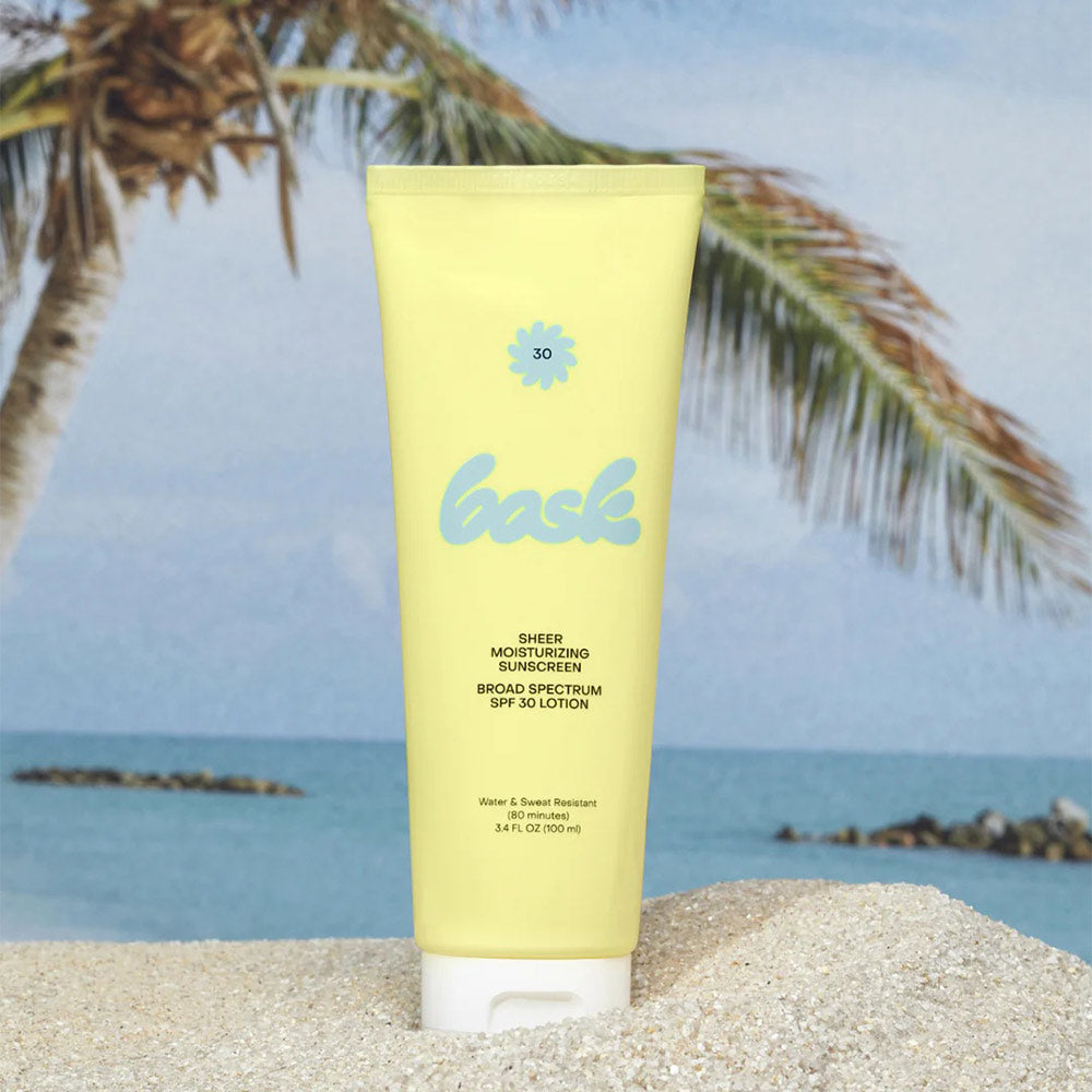 Bask sunscreen in the sand in front of the ocean