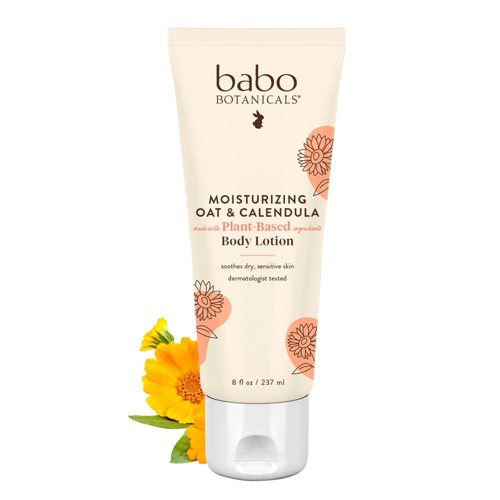 babo botanica moisturizing baby lotion next to yellow flowers on a white background