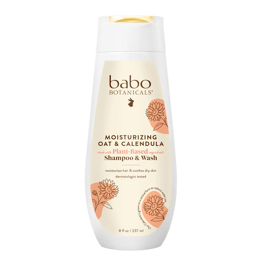 A bottle of Babo Botanicals Moisturizing Oat & Calendula Shampoo & Wash with illustrations of flowers on the label.