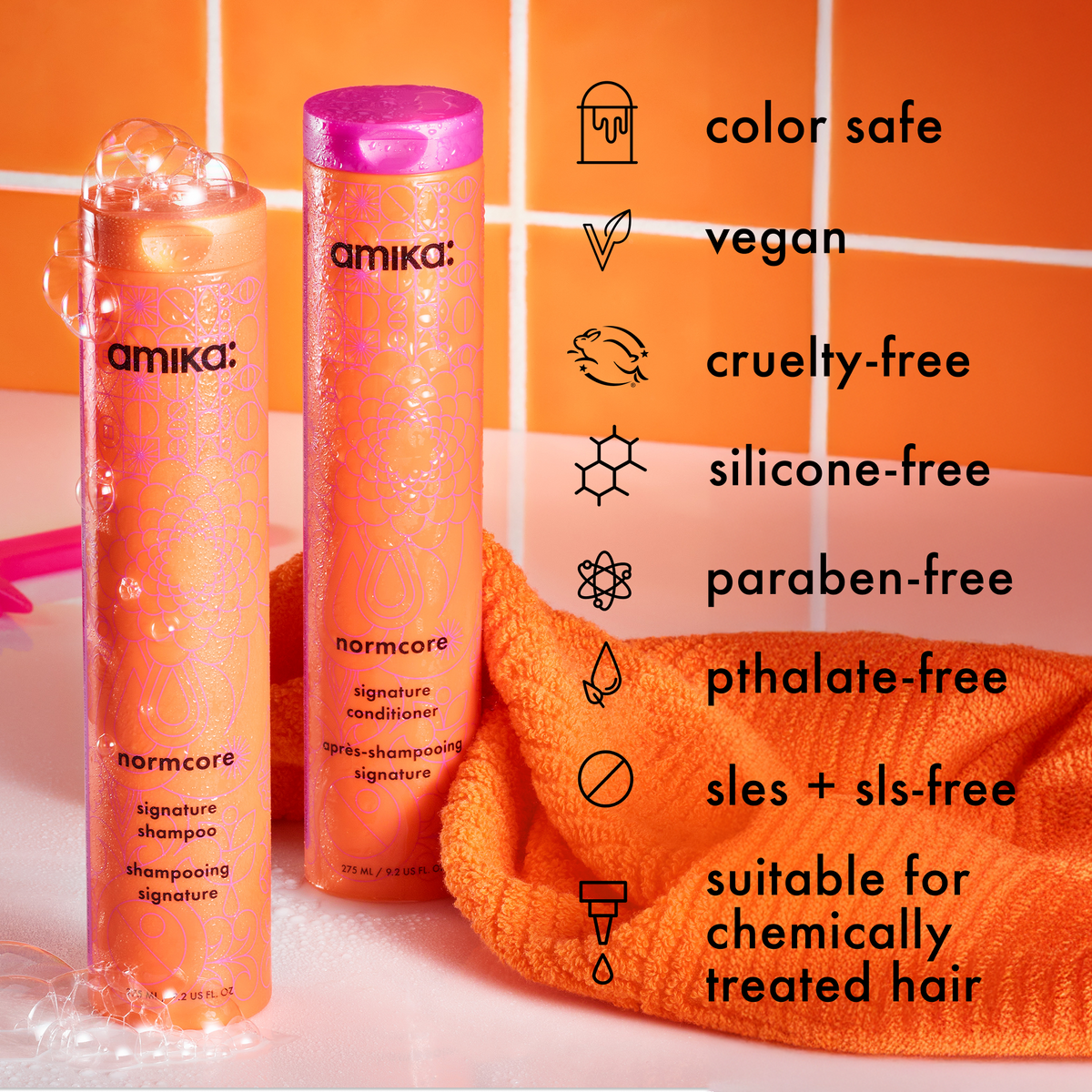 Amika Normcore shampoo and conditioner bottles with product features listed on an orange background