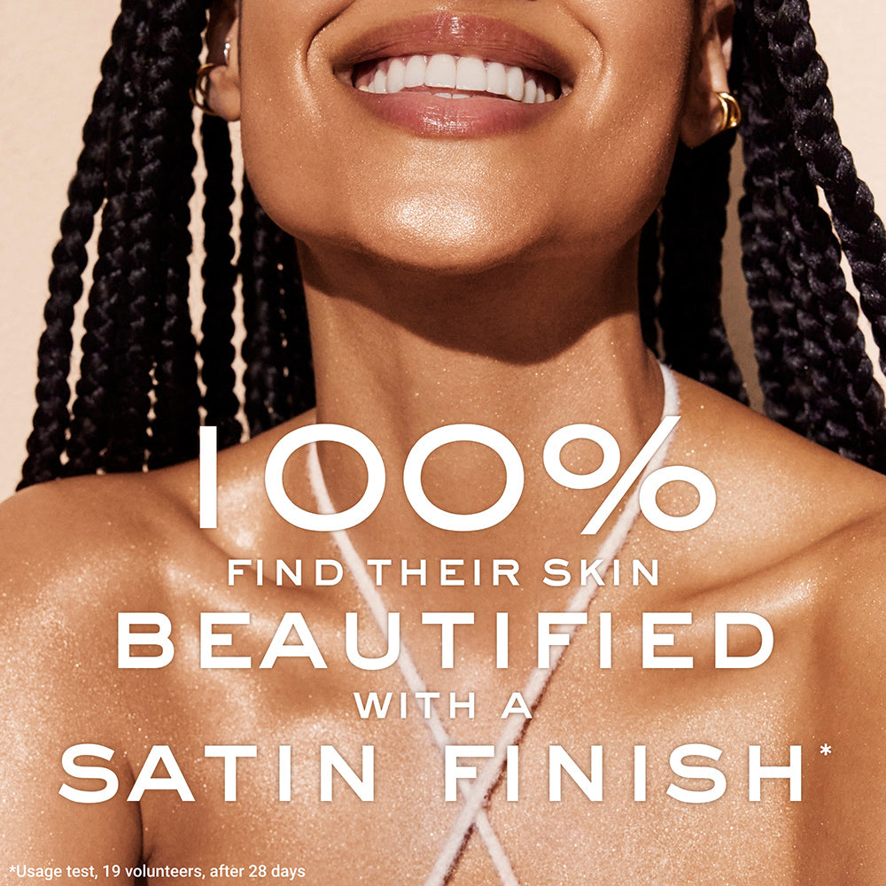Woman smiling wearing Nuxe oil.