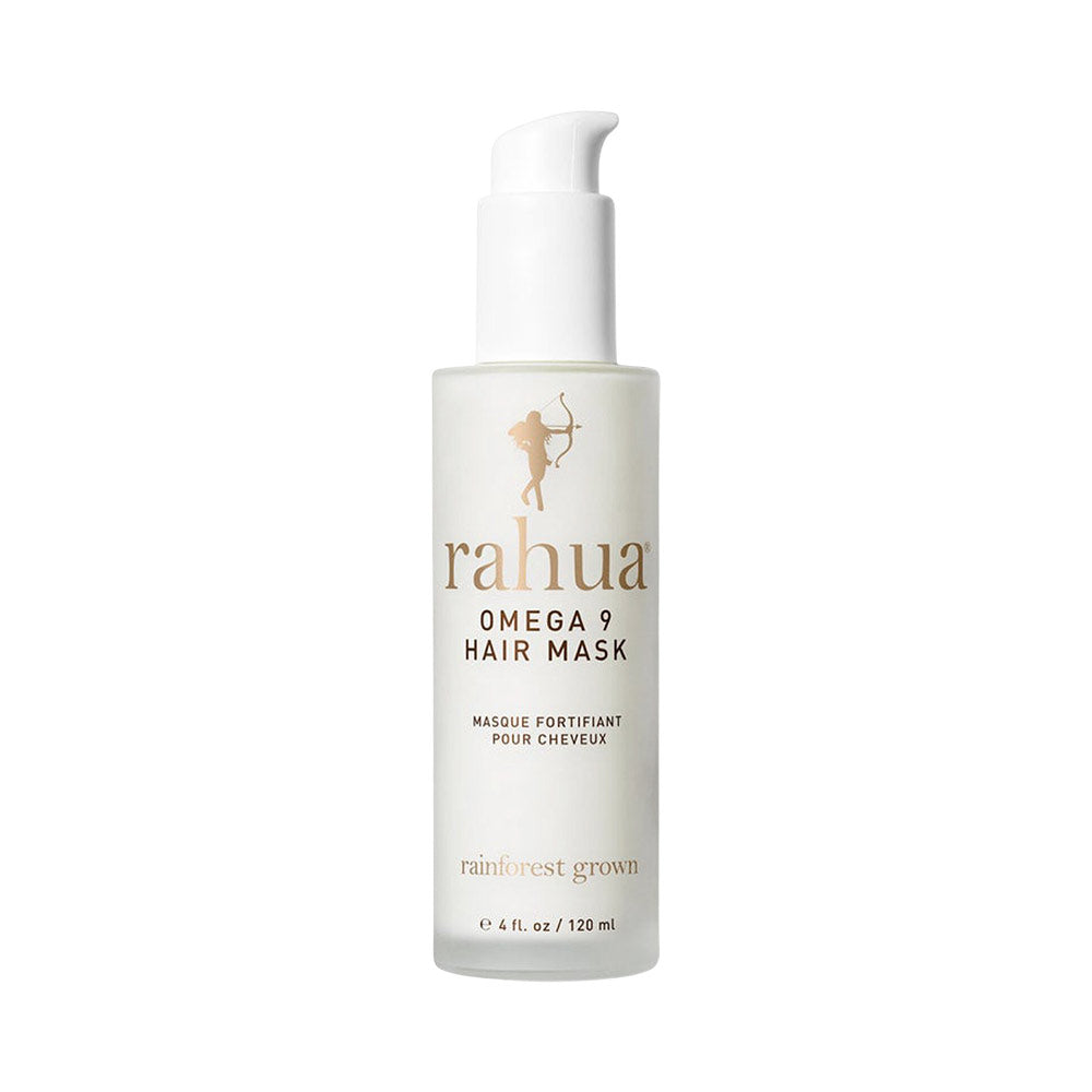 A bottle of Rahua Omega 9 Hair Mask, with a white pump dispenser, labeled as a hair fortifier with cheveux aromatic oils.