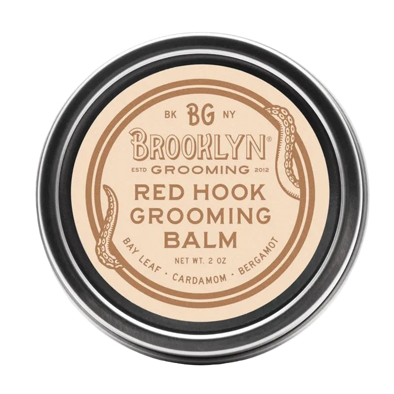 A metal tin container of Brooklyn Grooming Red Hook Grooming Balm with a beige label on the lid.