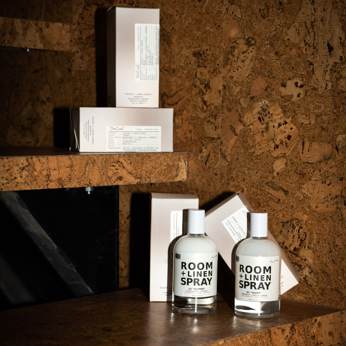 a few bottles and boxes of Dedcool Room and Line Spray on shelves. 