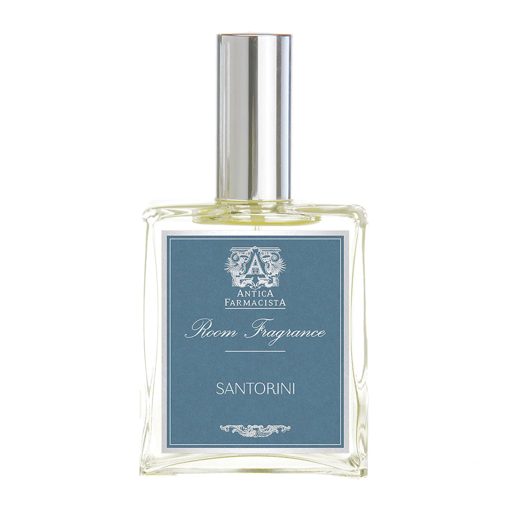 A glass bottle of Antica Farmacista Room Fragrance with a blue label reading 'SANTORINI'.