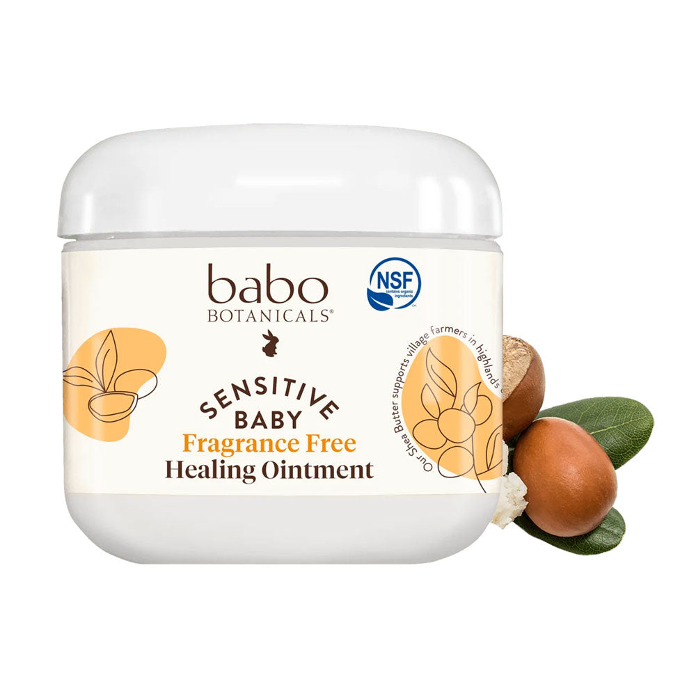 A white jar of Babo Botanicals Sensitive Baby Fragrance Free Healing Ointment with botanical design accents on the label.