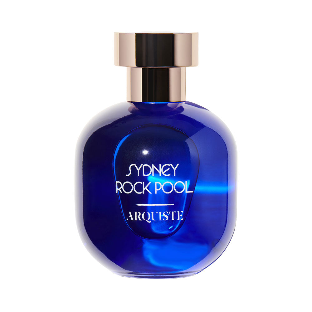 A blue glass bottle of 'Sydney Rock Pool - Eau de Parfum' by ARQUISTE with a gold-colored cap.