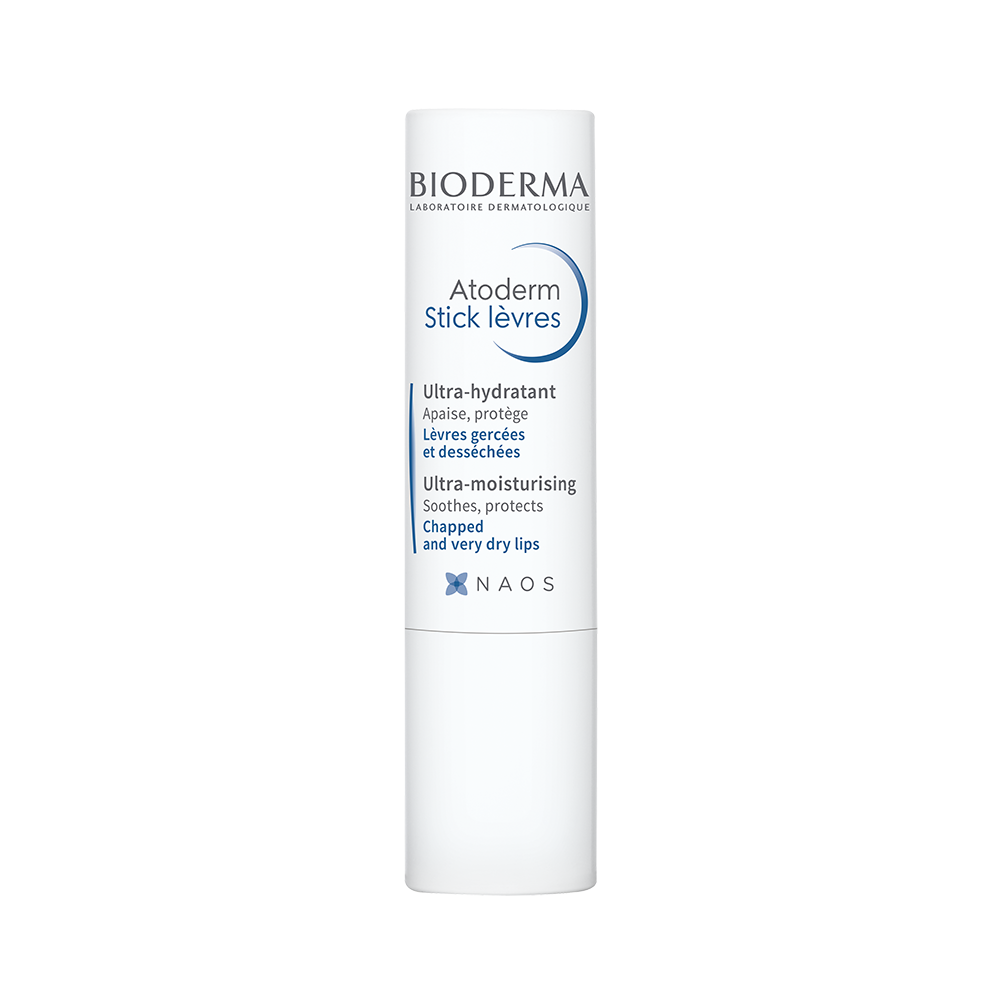 A white stick of Bioderma Atoderm Lip Stick with blue and green text detailing the product's properties.
