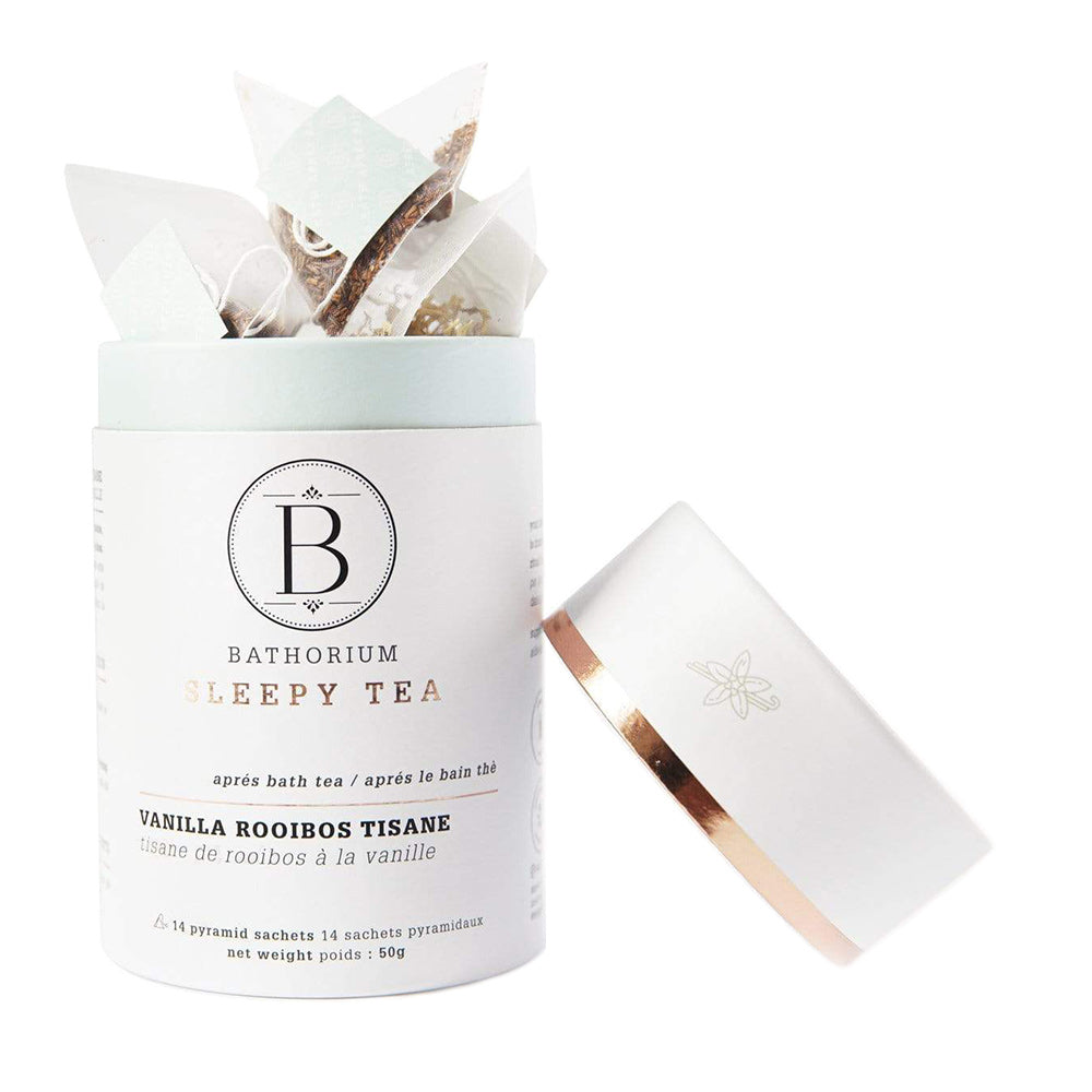 A white tin container next to its lid labeled 'BATHORIUM SLEEPY TEA' with a transparent section showing 14 pyramid tea bags inside.