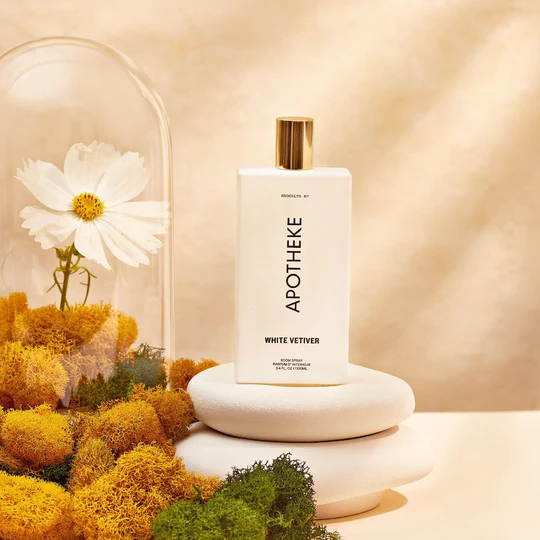 Apotheke product bottle next to a flower