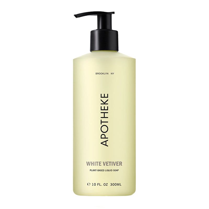A pump bottle of Apotheke White Vetiver liquid soap with a yellowish label and black pump.